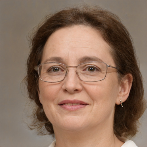 Joyful white adult female with medium  brown hair and green eyes