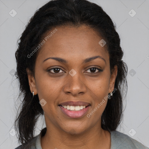 Joyful black young-adult female with long  brown hair and brown eyes