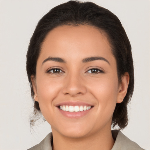 Joyful latino young-adult female with medium  brown hair and brown eyes