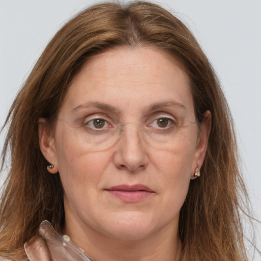 Joyful white adult female with long  brown hair and grey eyes