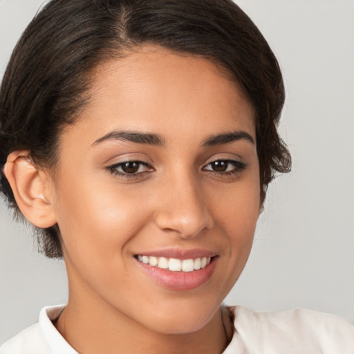 Joyful white young-adult female with medium  brown hair and brown eyes