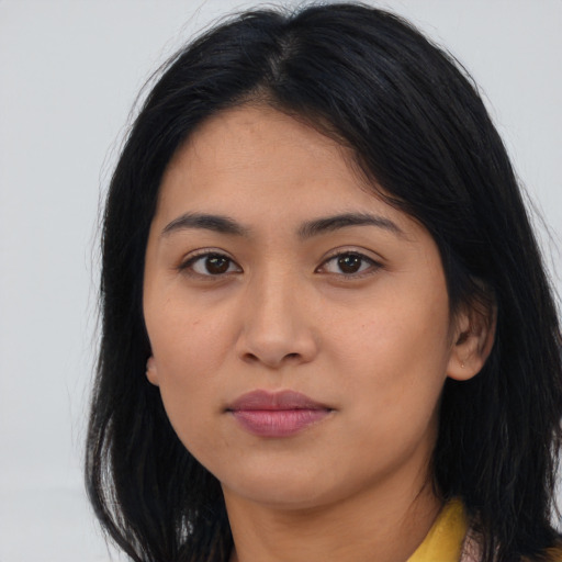 Joyful latino young-adult female with long  black hair and brown eyes