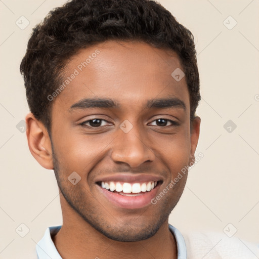 Joyful black young-adult male with short  brown hair and brown eyes