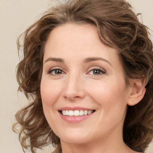 Joyful white young-adult female with medium  brown hair and green eyes