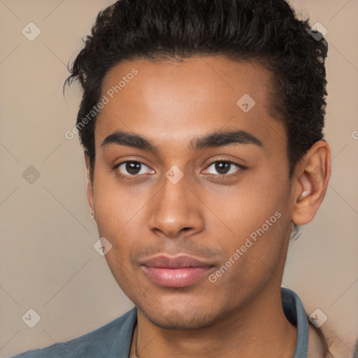 Joyful black young-adult male with short  brown hair and brown eyes