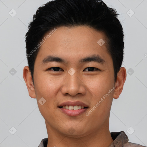 Joyful asian young-adult male with short  black hair and brown eyes