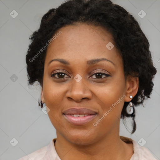 Joyful black adult female with medium  brown hair and brown eyes