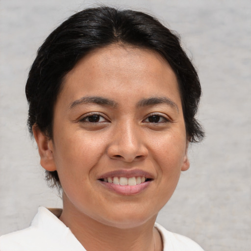Joyful asian young-adult female with short  brown hair and brown eyes