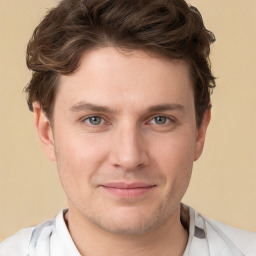 Joyful white young-adult male with short  brown hair and grey eyes