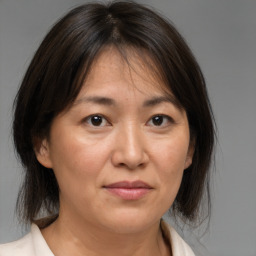 Joyful white adult female with medium  brown hair and brown eyes