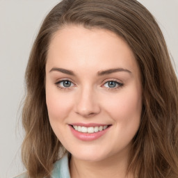 Joyful white young-adult female with long  brown hair and green eyes