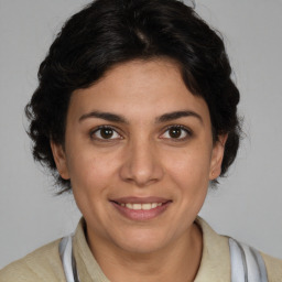 Joyful white young-adult female with medium brown hair and brown eyes