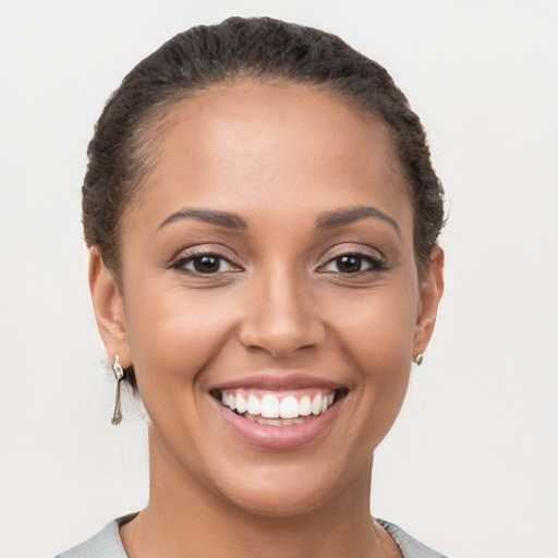 Joyful latino young-adult female with short  brown hair and brown eyes