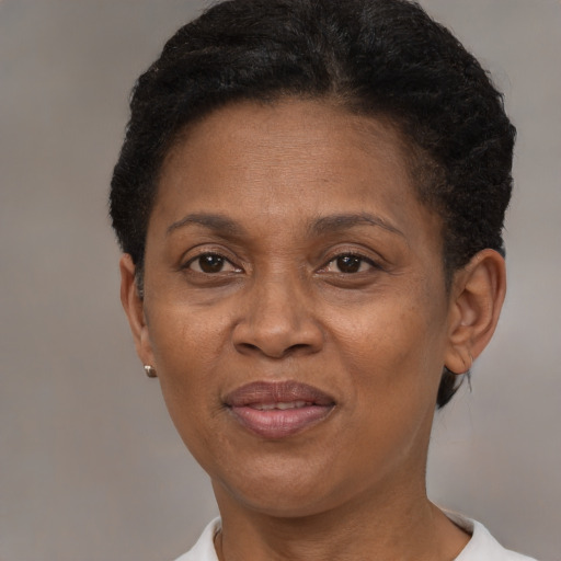 Joyful black adult female with short  brown hair and brown eyes