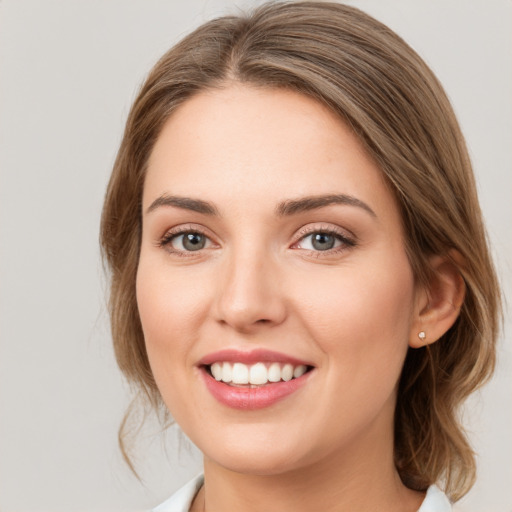 Joyful white young-adult female with medium  brown hair and green eyes