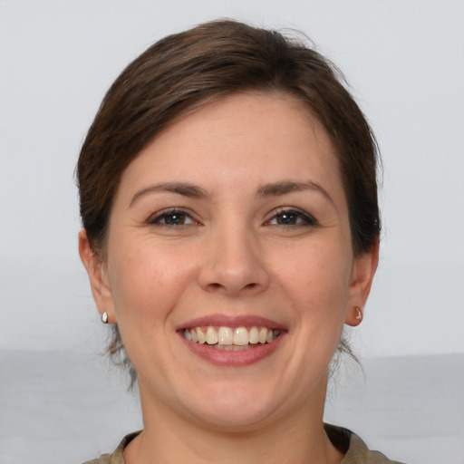 Joyful white young-adult female with medium  brown hair and brown eyes