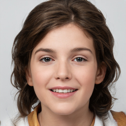 Joyful white child female with medium  brown hair and brown eyes