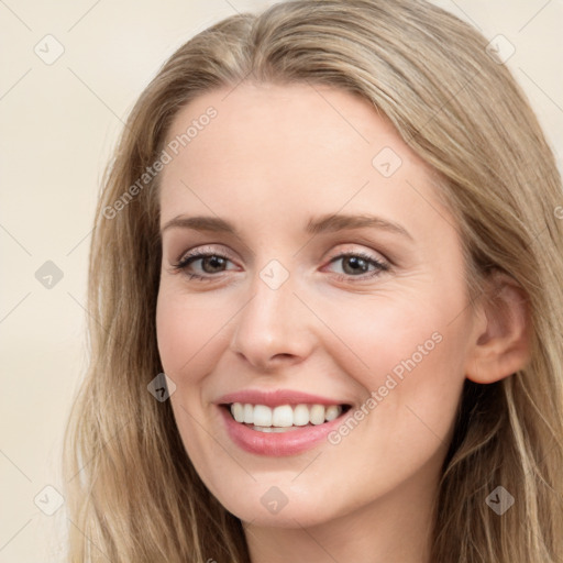 Joyful white young-adult female with long  brown hair and blue eyes