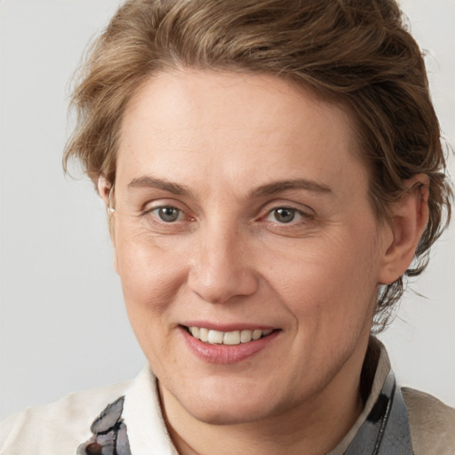 Joyful white adult female with medium  brown hair and brown eyes