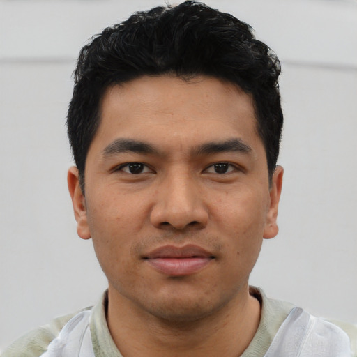 Joyful asian young-adult male with short  black hair and brown eyes
