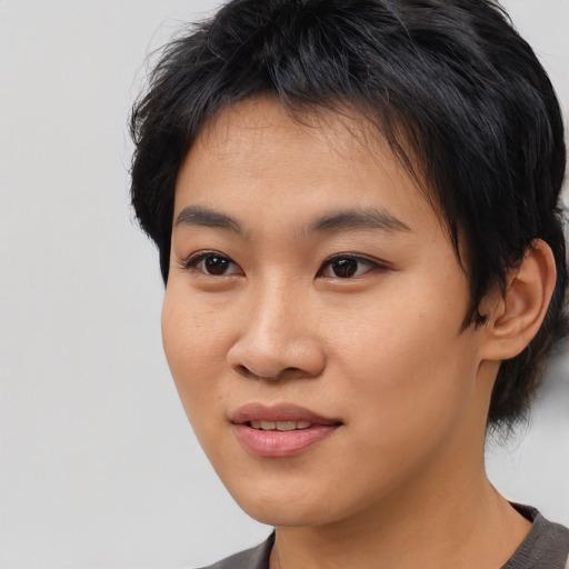 Joyful asian young-adult female with medium  black hair and brown eyes