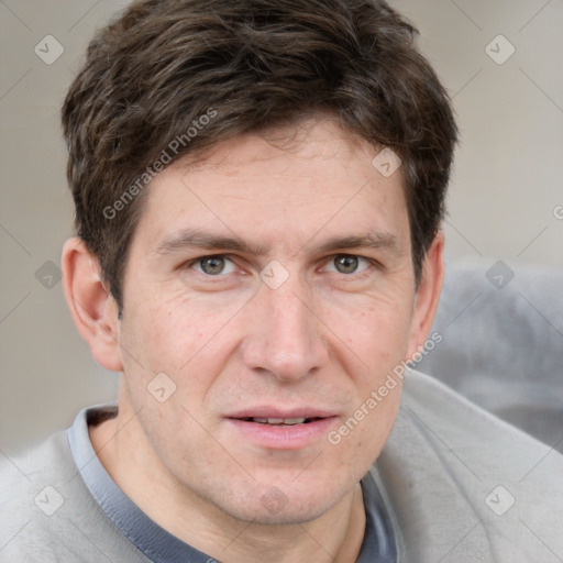 Joyful white adult male with short  brown hair and grey eyes