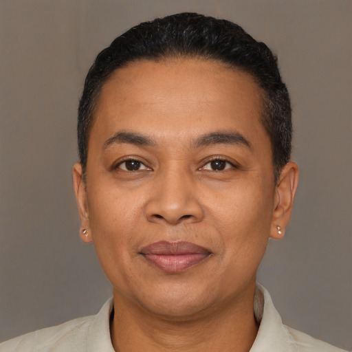 Joyful latino adult male with short  black hair and brown eyes