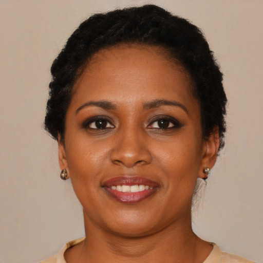 Joyful black young-adult female with short  brown hair and brown eyes