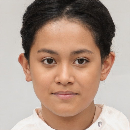 Joyful latino child female with short  brown hair and brown eyes