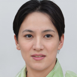 Joyful asian young-adult female with short  brown hair and brown eyes