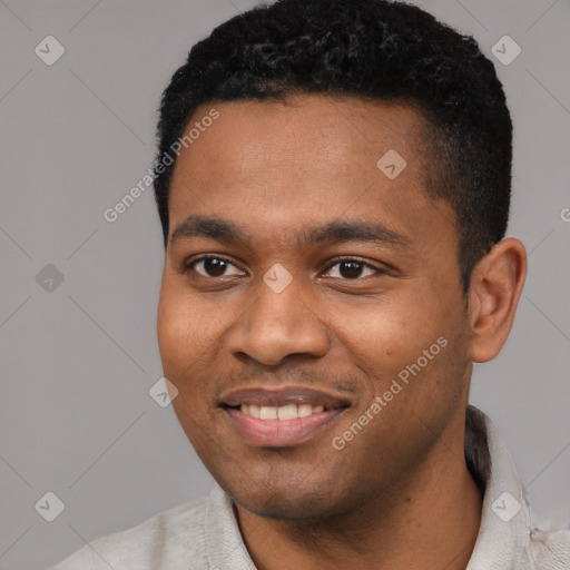 Joyful black young-adult male with short  black hair and brown eyes