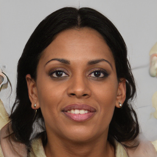 Joyful black adult female with medium  brown hair and brown eyes