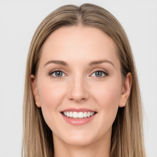 Joyful white young-adult female with long  brown hair and grey eyes