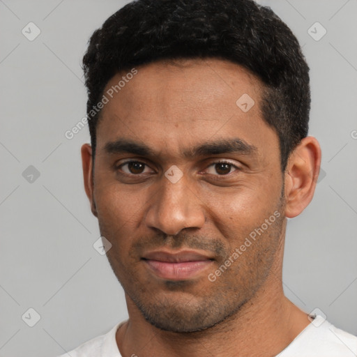 Joyful black young-adult male with short  black hair and brown eyes