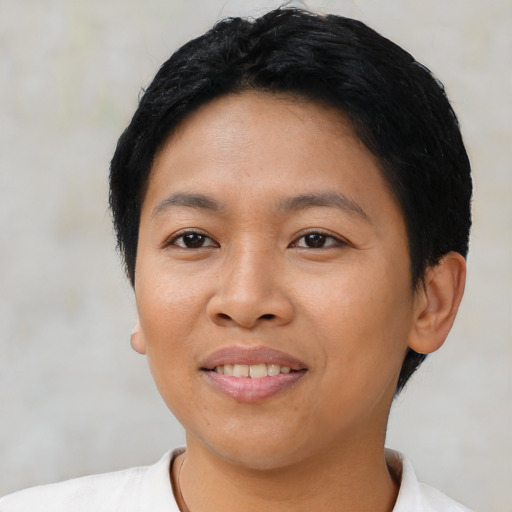 Joyful asian young-adult female with short  black hair and brown eyes