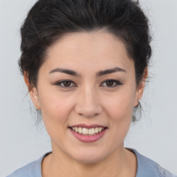 Joyful white young-adult female with medium  brown hair and brown eyes