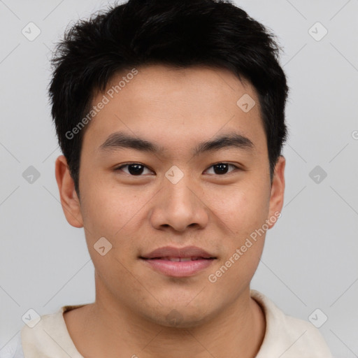 Joyful asian young-adult male with short  brown hair and brown eyes