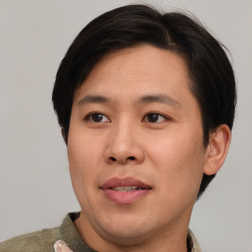 Joyful asian young-adult male with short  brown hair and brown eyes