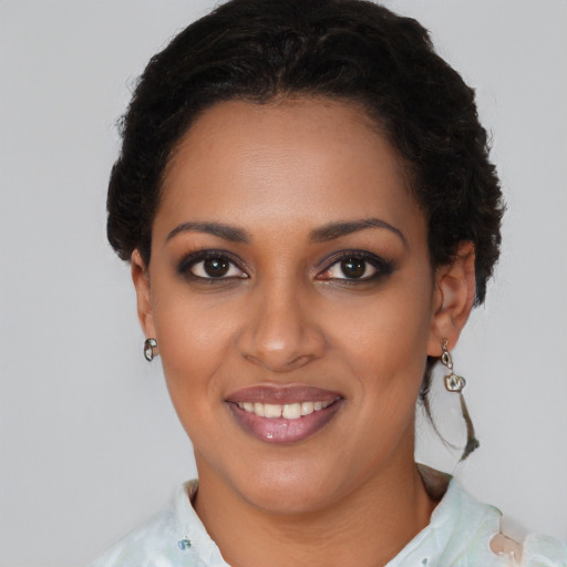 Joyful black young-adult female with short  brown hair and brown eyes