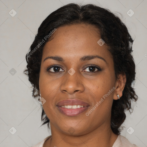 Joyful black adult female with medium  brown hair and brown eyes