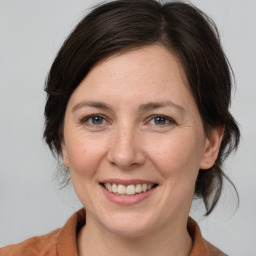 Joyful white adult female with medium  brown hair and brown eyes