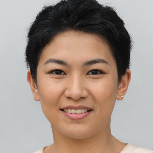 Joyful asian young-adult female with short  black hair and brown eyes