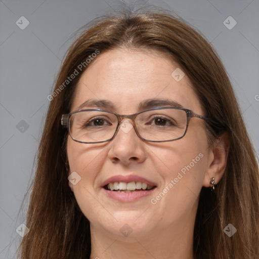 Joyful white adult female with long  brown hair and grey eyes