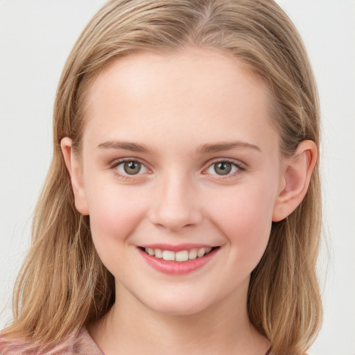 Joyful white child female with long  brown hair and blue eyes