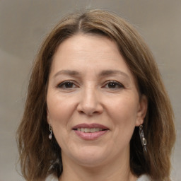 Joyful white adult female with medium  brown hair and brown eyes