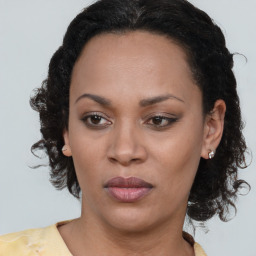 Joyful black adult female with medium  brown hair and brown eyes