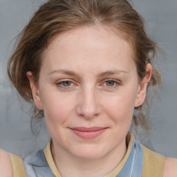 Joyful white young-adult female with medium  brown hair and blue eyes