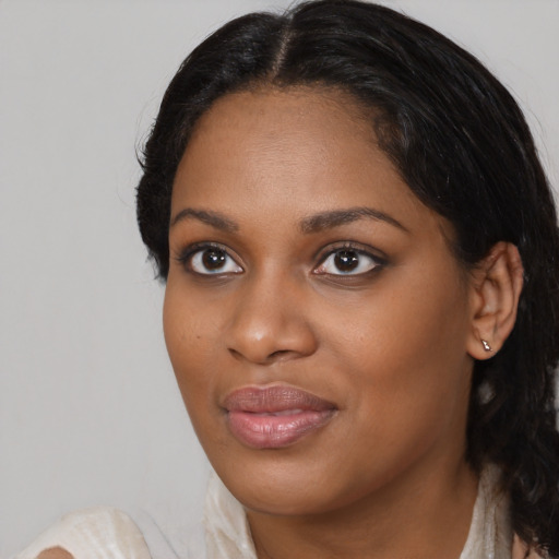 Joyful black young-adult female with medium  black hair and brown eyes