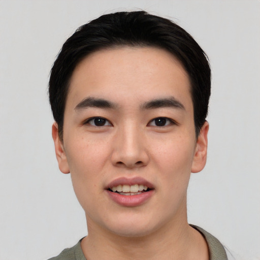 Joyful asian young-adult male with short  black hair and brown eyes