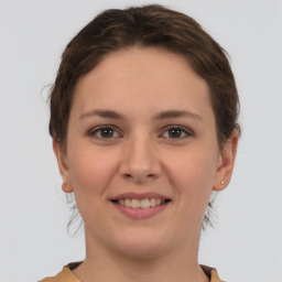 Joyful white young-adult female with short  brown hair and brown eyes